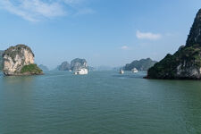 Cruising around Hạ Long Bay following dozens of other tour boats